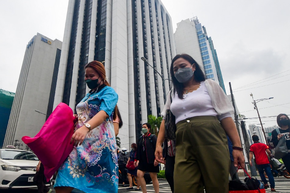 Pedestrians walk at a crossing in Makati City on July 12, 2022. Mark Demayo, ABS-CBN News/File