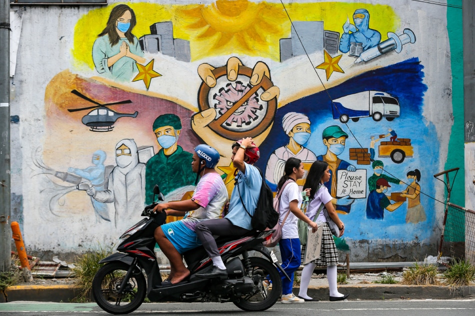 People pass by a COVID-19 pandemic-themed mural along Pedro Gil, Manila on May 10, 2023. Jonathan Cellona, ABS-CBN News