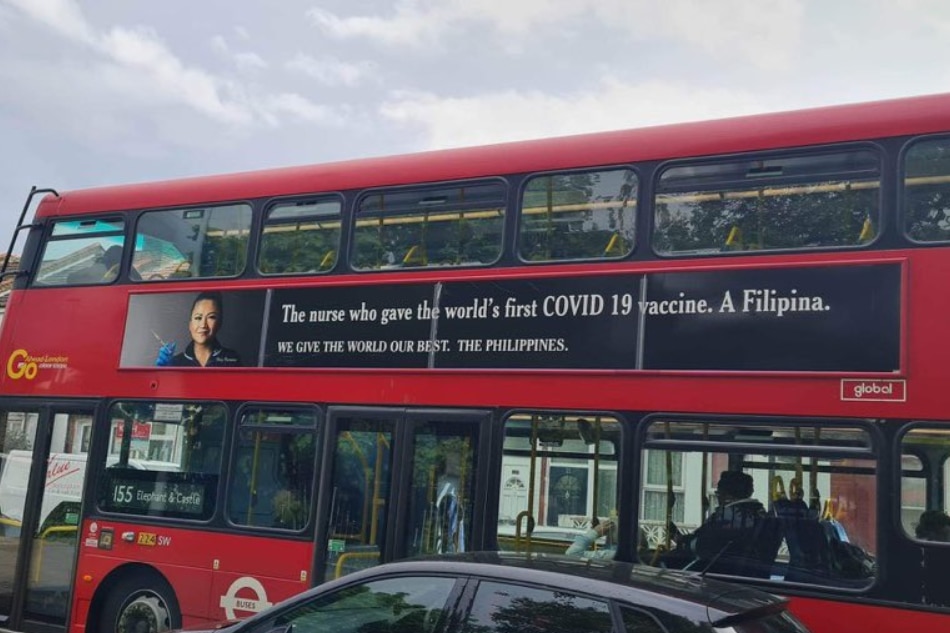 An advertisement featuring the Philippines' new country brand, 'We Give The World Our Best,' is seen on a double-deck bus in London, England on May 11, 2023. The ad features Filipina-British nurse May Parsons, known for administering the world's first COVID-19 vaccine. Rose Eclarinal, ABS-CBN News Europe Bureau