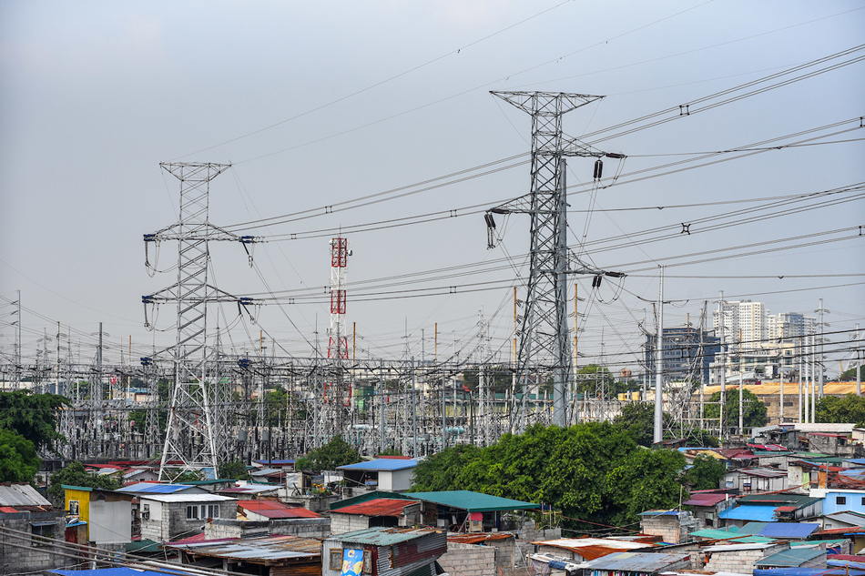 High voltage towers that support transmission lines for electrical power distribution in the Luzon grid is seen from a residential area in Baesa, Quezon City on Tuesday, May 9 2023. Maria Tan, ABS-CBN News
