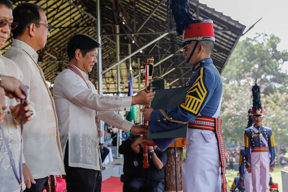 PMA Class of 2023 valedictorian Warren Leonor receives the Presidential Saber from President Ferdinand Marcos Jr. during the academy's graduation rites on May 21, 2023. PNA
