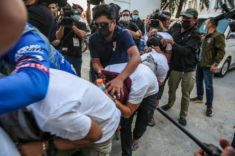 Operatives from the National Bureau of Investigation (NBI) escort six suspects in the killing of Negros Oriental Governor Roel Degamo for inquest proceedings at the Department of Justice headquarters in Manila on March 23, 2023. Jonathan Cellona, ABS-CBN News