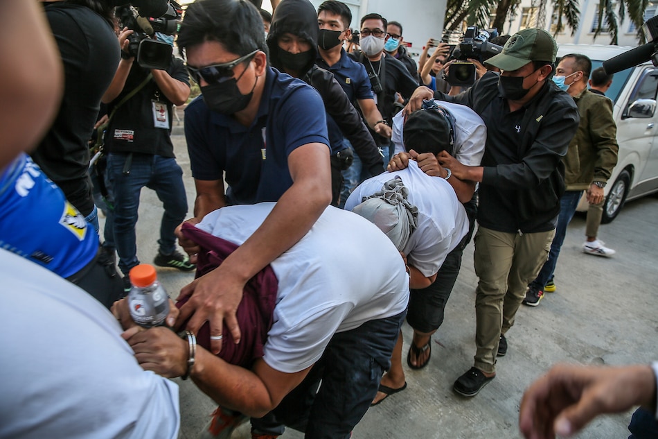 NBI operatives escort six suspects in the killing of Negros Oriental Gov. Roel Degamo for inquest proceedings at the Department of Justice headquarters in Manila on March 23, 2023. Jonathan Cellona, ABS-CBN News/File