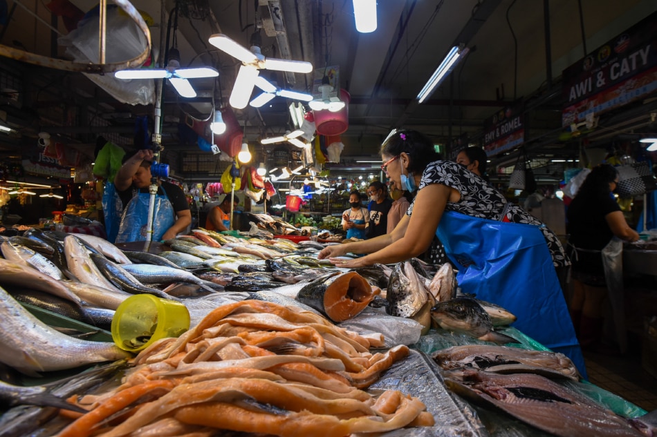 People buy various meat and produce at the Agora Public Market in San Juan City on Feb. 21, 2023. Maria Tan, ABS-CBN News