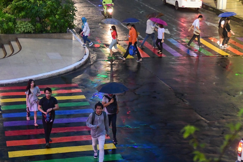 Pedestrians cross a section with the colors of the rainbow in Quezon City on June 25, 2018. The pedestrian lanes were colored in support of the LGBT community for Pride Month. File/Mark Demayo, ABS-CBN News