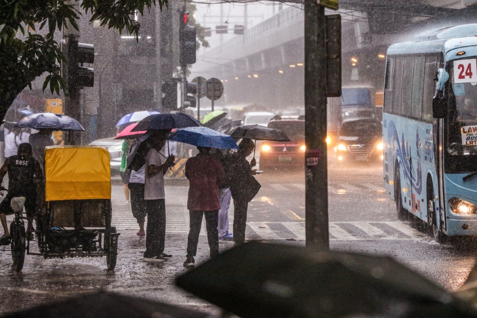 Pedestrians and motorists navigate through rain and flood after a sudden downpour in Manila City on May 26, 2023. Jonathan Cellona, ABS-CBN News/File