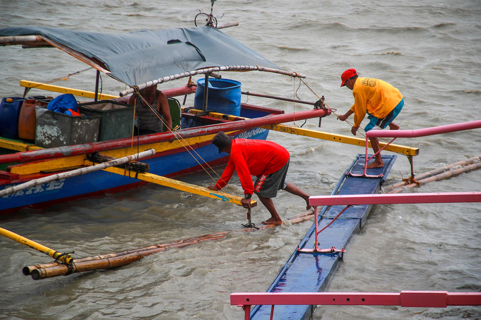 Fisherfolk and port workers attend to their boats amid strong winds at the Binangonan Fish Port in Rizal on May 31, 2023. Jonathan Cellona, ABS-CBN News