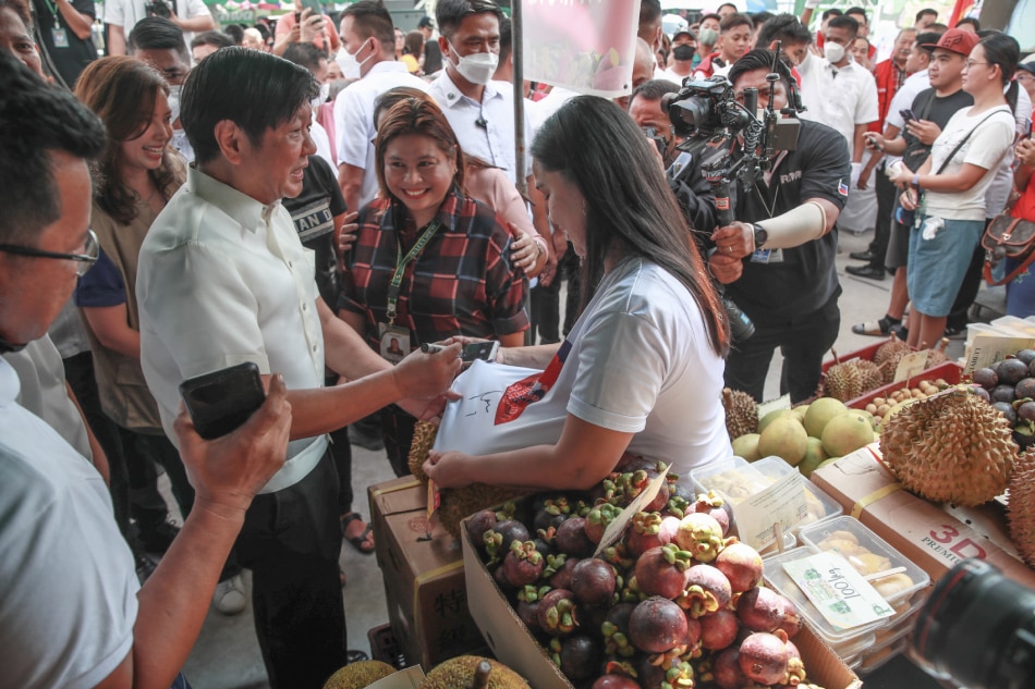 President Ferdinand Marcos Jr. looks at products on display as he interacts with sellers during the launch of 'Kadiwa Ng Pangulo,' at the Limay Public Market in Limay, Bataan on March 31, 2023. Jonathan Cellona, ABS-CBN News/PPA pool/file