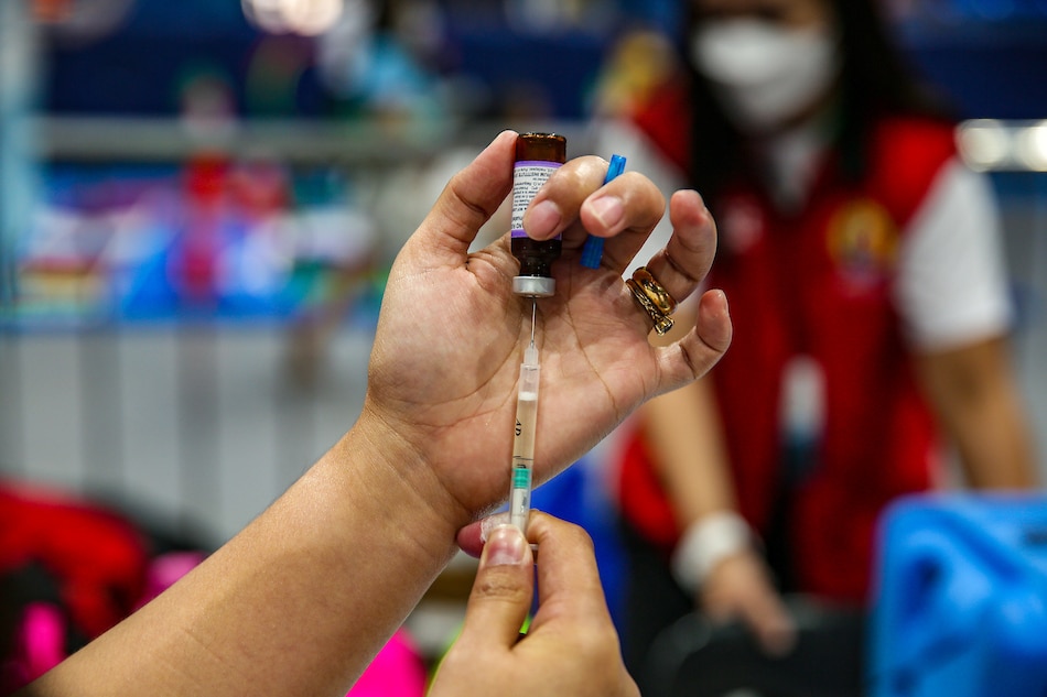 Health workers prepare measles and rubella vaccines as residents arrive to have their children vaccinated during the launch of The Department of Health’s (DOH) “Chikiting Ligtas” Vaccine Supplemental Immunization activity at the FilOil Flying V Centre in San Juan City on April 27, 2023. Jonathan Cellona, ABS-CBN News