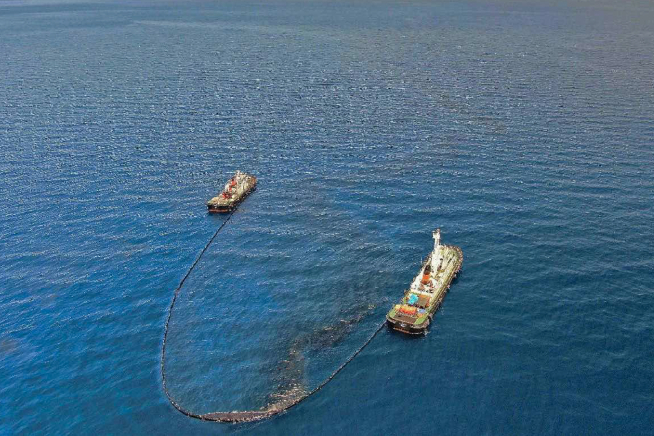 The Philippine Coast Guard deploy an oil spill boom and skimmer with manual scooping around the suspected area of the sunken MT Princess Empress approximately 7.1 nautical miles northeast of the shorelines of Balingawan Port, Lucta Port, and Buloc Bay in Oriental Mindoro on March 14, 2023. Photo courtesy of Malayan Towage and Salvage Corporation/Philippine Coast Guard