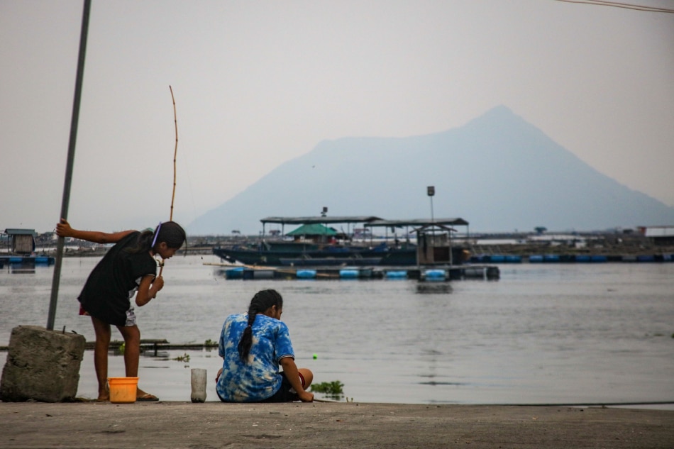 Fisherfolk continue with their work amidst a cloudy afternoon in Laurel Batangas on June 7, 2023. Local government officials advised residents near the lake to take precautions for possible emissions of volcanic smog from the Taal volcano. Jonathan Cellona, ABS-CBN News