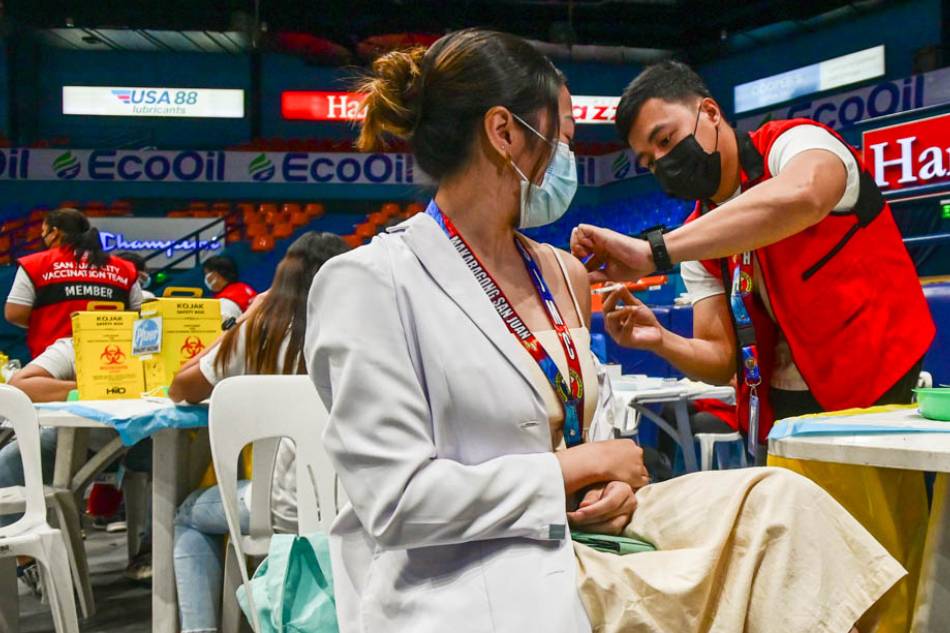 Healthcare workers from different health institutions in San Juan City receive the COVID-19 bivalent vaccine at the FilOil EcoOil Centre. Maria Tan, ABS-CBN News/File