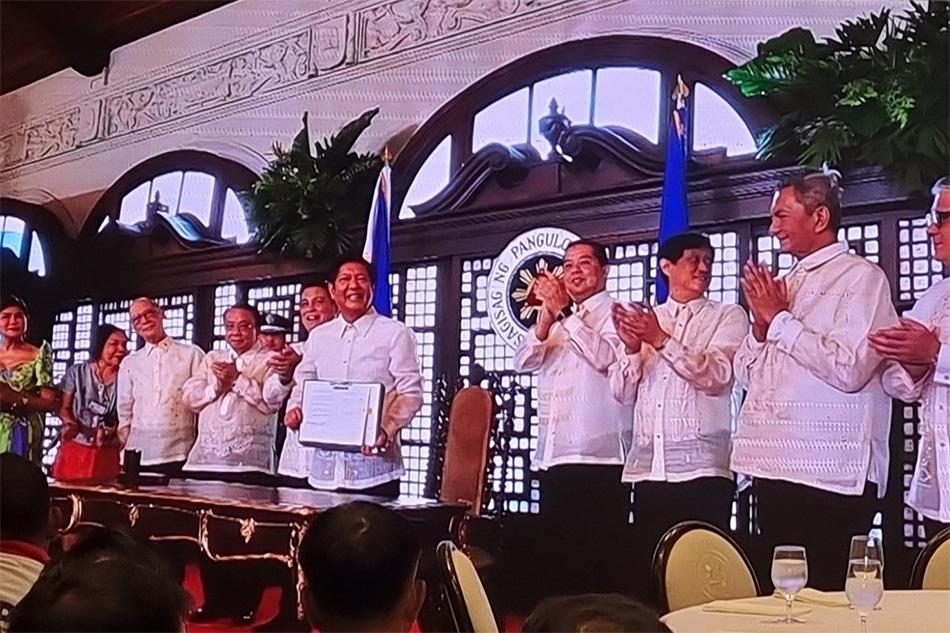 President Ferdinand Marcos, Jr signs Republic Act No. 11953 or the New Agrarian Emancipation Act. Job Manahan, ABS-CBN News 