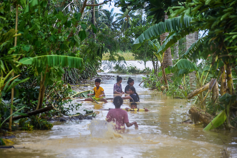 Children play along a flooded street in Purok Sinamar in Barangay Libertad, Abulug, Cagayan, a day after Typhoon Egay brought heavy rains on July 27, 2023. Maria Tan, ABS-CBN News