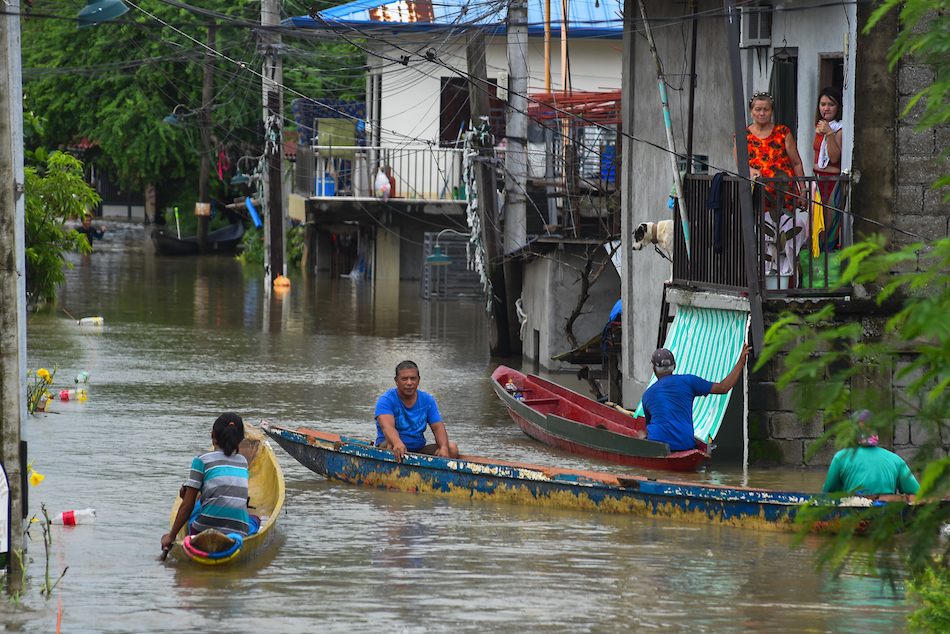 Residents of Barangay Frances in Calumpit, Bulacan use boats and improvised flotation devices as the flood in their community reach neck-deep on July 31, 2023 due to continuous rains for days. Maria Tan, ABS-CBN News