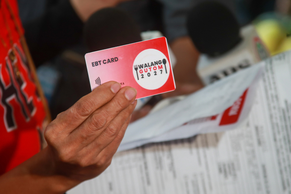 Beneficiaries use the electronic benefit transfer cards during the Walang Gutom 2027: Food Stamp program kick-off activity at the Don Bosco Youth Center in Tondo,Manila on July 18, 2023. Jonathan Cellona, ABS-CBN News