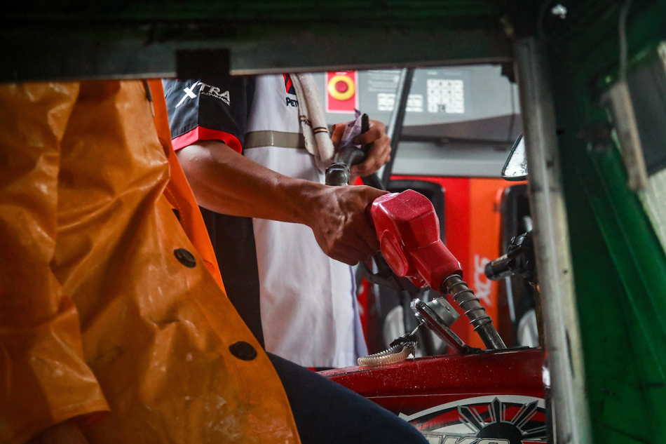 An attendant fills a tricycle’s gas tank at a refilling station along Timog Avenue in Quezon City on August 1, 2023. Jonathan Cellona, ABS-CBN News/File