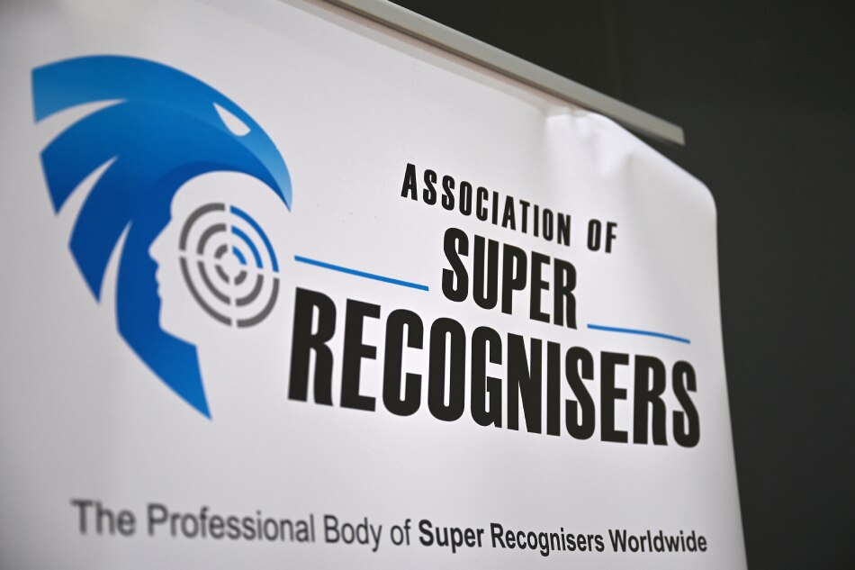 A sign shows The Association of Super Recognisers logo during a media event at a Thames Valley Police training facility in Sulhamstead near Reading on August 24, 2023. Artificial intelligence and facial recognition software are seen by some as the future of crime-fighting around the world. But British police say it has to go hand in hand with more traditional methods of detection, including the use of so-called 'super-recognisers.' Justin Tallis, AFP
