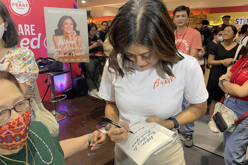 ABS-CBN News anchor Bernadette Sembrano signs a copy of her book, 'When Bad News Is Good News,' during its launch in Pasay City. Izzy Lee, ABS-CBN News