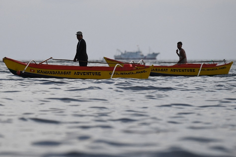 This photo taken on September 2, 2023 shows Philippine fishermen working near the Chinese-controlled Scarborough Shoal in disputed waters of the South China Sea. China, which claims sovereignty over almost the entire South China Sea, snatched control of Scarborough Shoal from the Philippines in 2012. Ted Aljibe, AFP