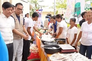 Marcos launches food stamp program in Surigao, gives rice