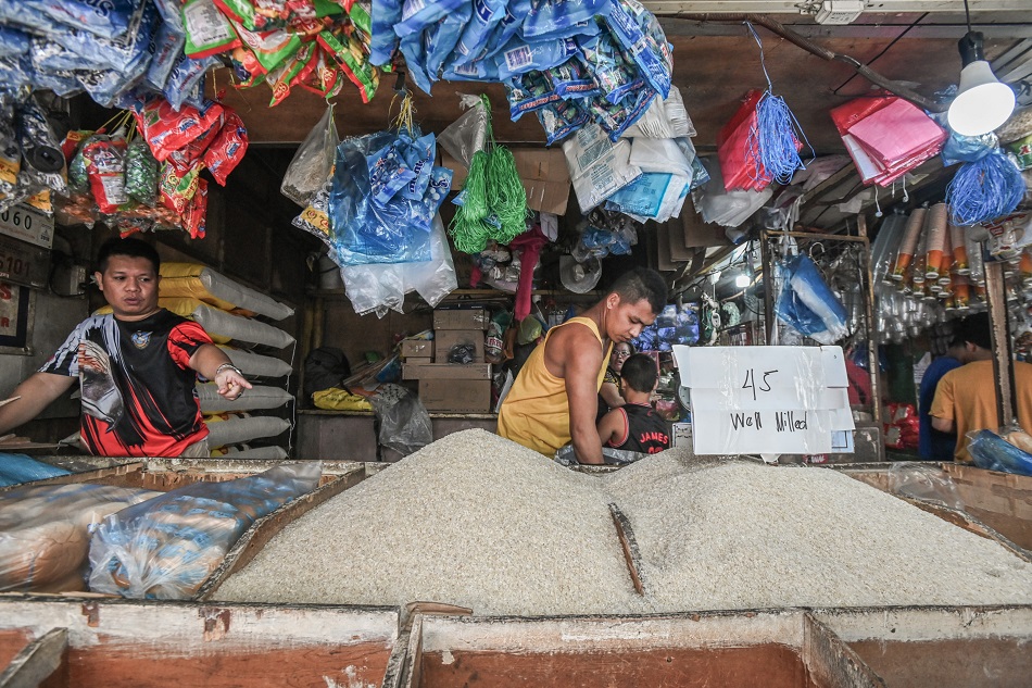 Vendors put up a P45 sign at a box of well-milled rice at the Mega Q-Mart in Quezon City on September 3, 2023, in compliance with the implementation of a price ceiling for regular and well-milled rice in the country. Maria Tan, ABS-CBN News