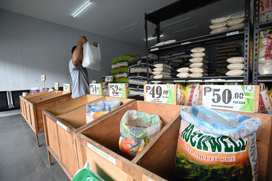 A worker arranges sacks of rice at a local rice store in Quezon City, October 4, 2023. Maria Tan, ABS-CBN News