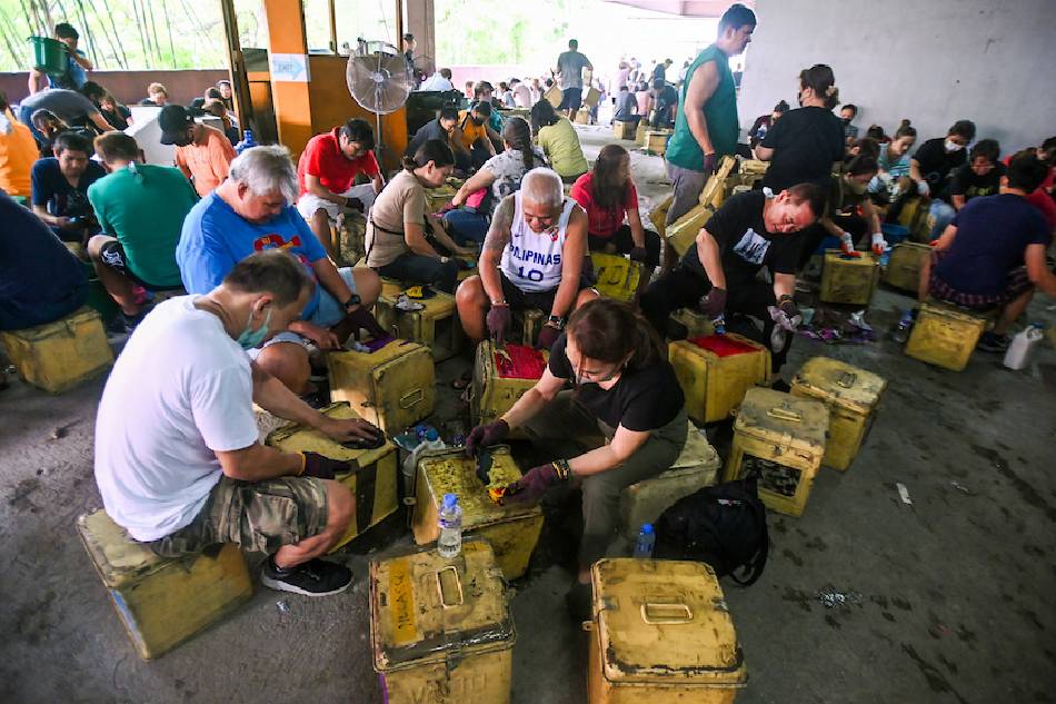 Employees of Manila City Hall clean and prepare ballot boxes for the upcoming Barangay and Sangguniang Kabataan Election at the Comelec warehouse in Park N Ride in Manila on September 16, 2023. Maria Tan, ABS-CBN News
