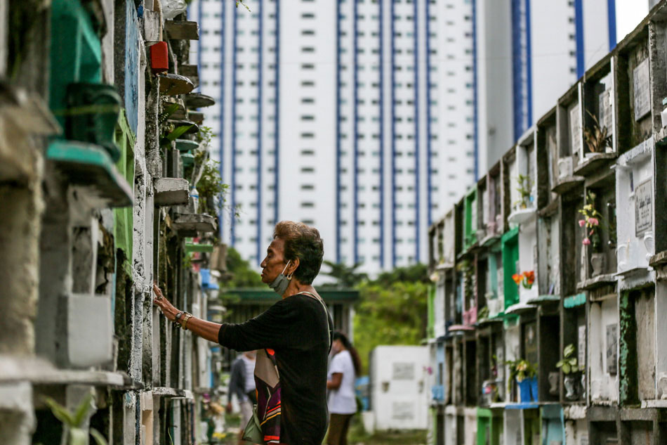 A woman offers prayers for her departed loved ones at the Manila South Cemetery on October 31, 2023. Jonathan Cellona, ABS-CBN News