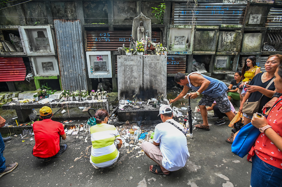 Filipinos visit the graves of their departed loved ones at Bagbag Public Cemetery in Quezon City as they mark All Saints