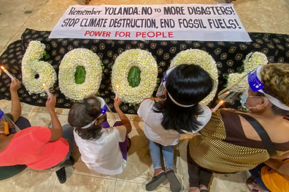 Climate advocates light candles as they commemorate the 8th anniversary of Typhoon Yolanda at the Our Lady of Remedies Parish, Malate, Manila on November 08, 2021. The group paid tribute to the more than 6000 lives lost during the deadly Category 5 typhoon that hit Eastern Visayas in 2013. Jonathan Cellona, ABS-CBN News/File.