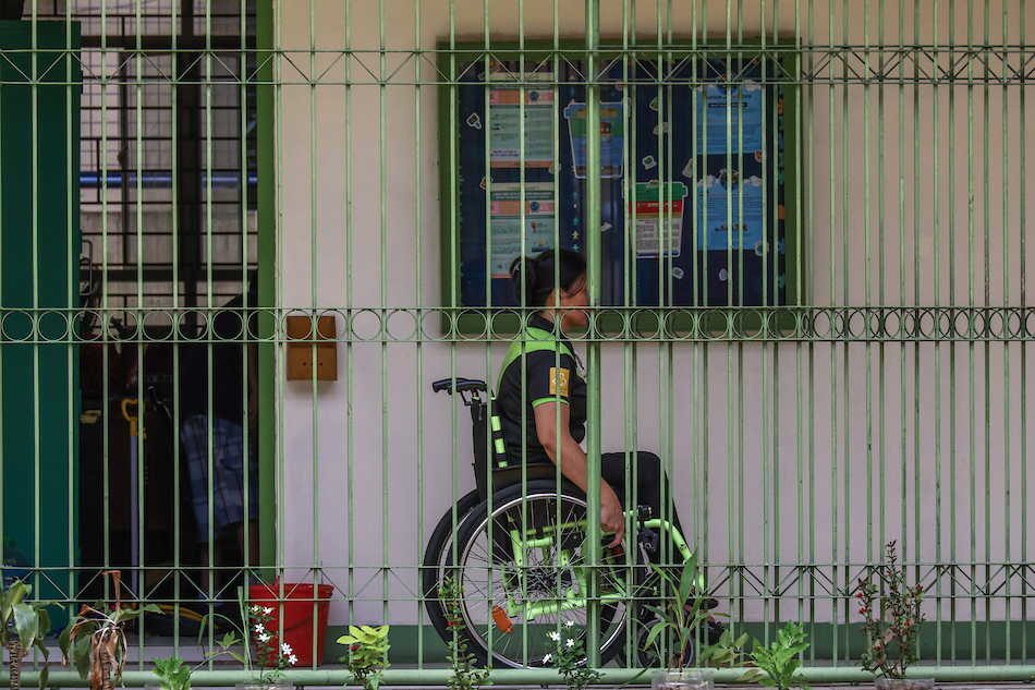 Leah Garcia, 49, a person with disability (PWD) who is a Special Education (SPED) teacher cleans her classroom during the Brigada Eskwela Kick Off with theme 
