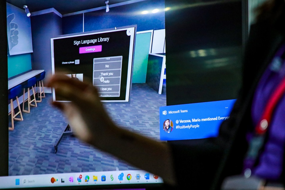 Employees demonstrate the use of VR assistive technology devices used by Accenture for its workers with disabilities at the company