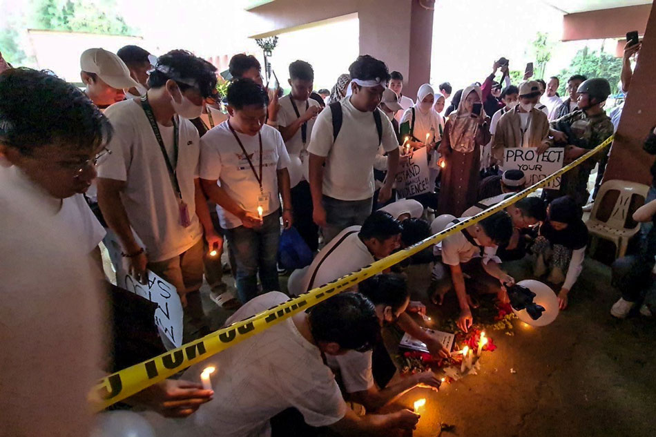Students and alumni of Mindanao State University (MSU) light candles on Dec. 5, 2023 in front of the gymnasium inside the MSU campus in Marawi City, site of the deadly bombing during a Mass on December 3. Dennis Datu, ABS-CBN News