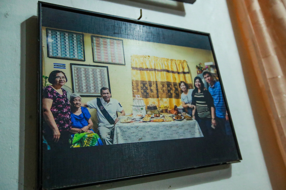 Perla Reprado shows pictures of her family during past Noche Buenas at their home in Navotas City on December 4, 2023. Reprado said Christmas dinner this year would have to be a little simple because of budget constraints. Jonathan Cellona, ABS-CBN News