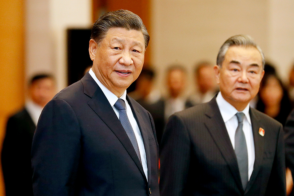 Chinese President Xi Jinping (L) and Chinese Foreign Minister Wang Yi (R) attend a meeting with Vietnamese Chairman of the National Assembly Vuong Dinh Hue (not pictured) at the National Assembly in Hanoi, Vietnam, Dec. 13, 2023. EPA-EFE/Minh Hoang/Pool 