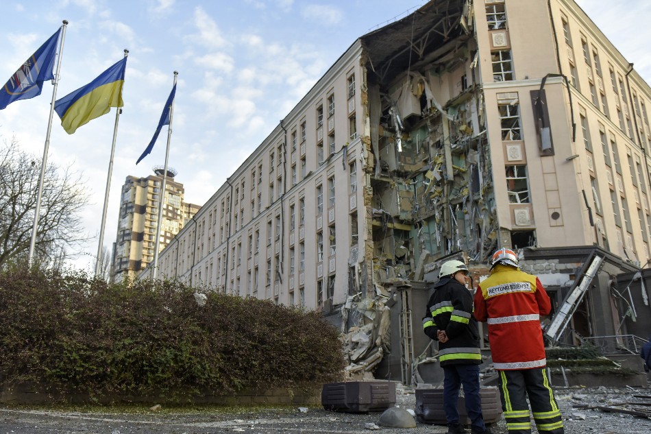 Ukrainian rescuers stand in front of the damaged hotel building that was hit in a missile strrike in downtown Kyiv (Kiev), Ukraine, 31 December 2022. Russian missiles targeted major cities across Ukraine on 31 December prior to the New Year celebration. Kyiv Mayor Vitaliy Klitschko reported explosions and destruction in three districts of the capital. At least one person was killed, Klitschko said. Russian troops entered Ukraine on 24 February 2022 starting a conflict that has provoked destruction and a humanitarian crisis. EPA-EFE/OLEG PETRASYUK