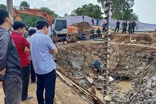 Vietnam rescuers battle to save boy from 35-meter hole