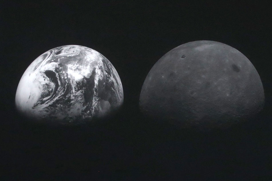 Photos of the moon (R) and Earth (L), taken by South Korea's first lunar orbiter, Danuri, are displayed at the presidential office in Seoul, South Korea, Jan. 3, 2023. EPA-EFE/Yonhap/Pool