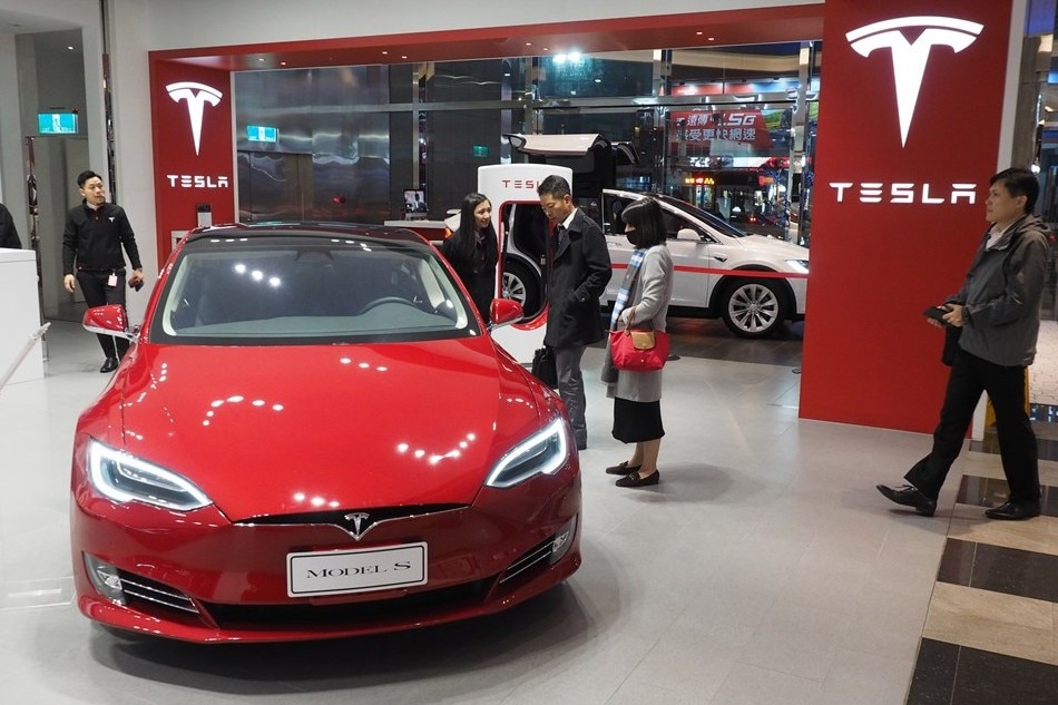 People look at a Tesla Model S electric car in a Tesla Store in Taipei, Taiwan, Dec. 13, 2018. David Chang, EPA-EFE/File