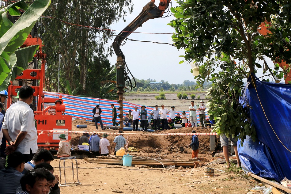 A handout photo made available by Vietnam News Agency shows people gathering at the site where a 10-year-old boy is stuck in a 35-meter deep hole in Dong Thap Province, Vietnam, 02 January 2023 (issued 03 January 2023). Rescuers have raced to free the boy trapped in shaft for more than two days, according to media reports. EPA-EFE/VIETNAM NEWS AGENCY/HANDOUT