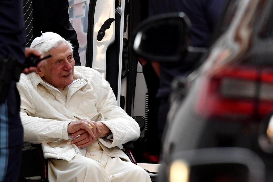 Pope Emeritus Benedict XVI (C) sits in a wheelchair as he leaves the house of his brother Georg Ratzinger, after a visit in Regensburg, Germany on June 18, 2020. Philipp Guelland, EPA-EFE/File