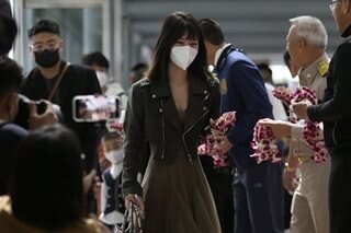 Flowers and face masks as Chinese tourists return to Thailand