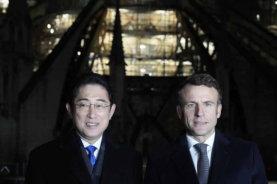 French President Emmanuel Macron (R) and Japanese Prime Minister Fumio Kishida visit Notre Dame Cathedral, under reconstruction since it was ravaged by a fire in 2019, in Paris, France, 09 January 2023. Kishida started a weeklong trip to Europe and North America on 09 January and is to hold talks with Macron on key global issues, including the war in Ukraine. EPA-EFE/Thibault Camus