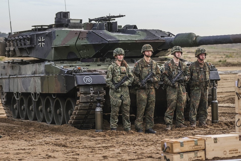 Soldiers stand next to a Leopard 2 battle tank during a media presentation for the annual Land Operation Exercise of the German armed forces Bundeswehr in Bergen, northern Germany, 17 October 2022. The exercise is taking place with up to 2,500 soldiers at its core on the Bergen and Munster military training areas in Lower Saxony. EPA-EFE/FRIEDEMANN VOGEL