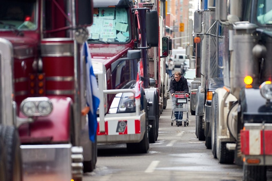 A trucker comes back after he did his grocery shopping near the parlement hill... in downtown Ottawa, Ontario, Canada, 11 February 2022. EPA-EFE/ANDRE PICHETTE/FILE