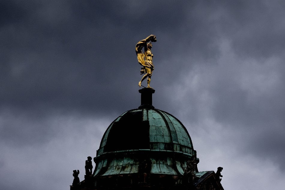 Dark cloud are seen over a statue on the top of cupola of University of Potsdam, in Potsdam, Germany, 18 August 2021. EPA-EFE/FILIP SINGER
