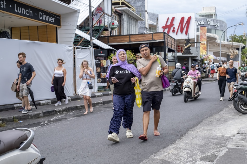 Tourists walk around Seminyak, Bali, Indonesia, 31 January 2023. Indonesia targets over 250.000 Chinese tourist arrivals in 2023, after China reopened its borders following three years of Covid closure, the Minister of Tourism and Creative Economy of Indonesia said on 26 January. EPA-EFE/MADE NAGI