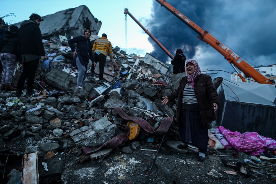 A woman reacts as emergency personnel carry out a search and rescue operation at the site of a collapsed building following an earthquake in Iskenderun, district of Hatay, Turkey, Feb. 7, 2023. More than 5,000 people were killed and thousands more injured after a major 7.8 magnitude earthquake struck southern Turkey and northern Syria on Feb. 6. Authorities fear the death toll will keep climbing as rescuers look for survivors across the region. Erdem Sahin, EPA-EFE