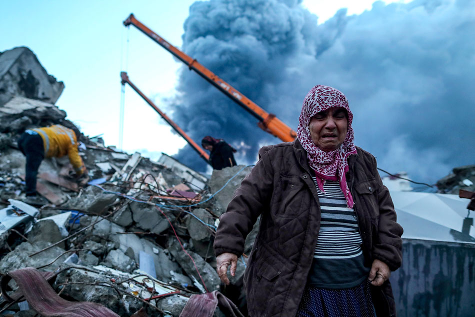 A woman reacts as emergency personnel search for victims at the site of a collapsed building after an earthquake in Iskenderun, district of Hatay, Turkey, February 7, 2023. Courtesy: Erdem Sahin/EPA